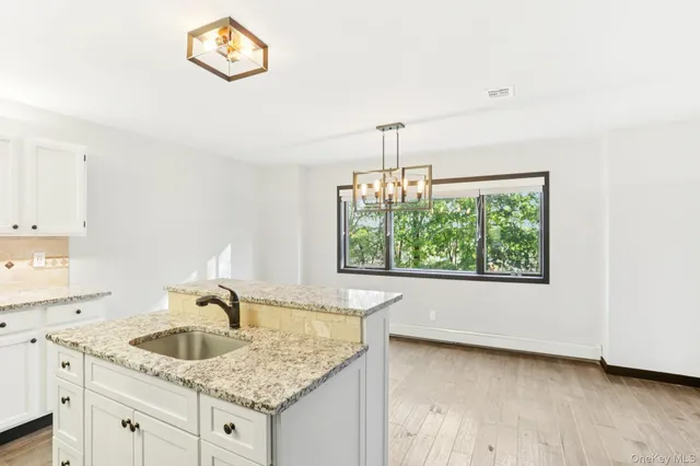 a kitchen with a sink and a wooden floor