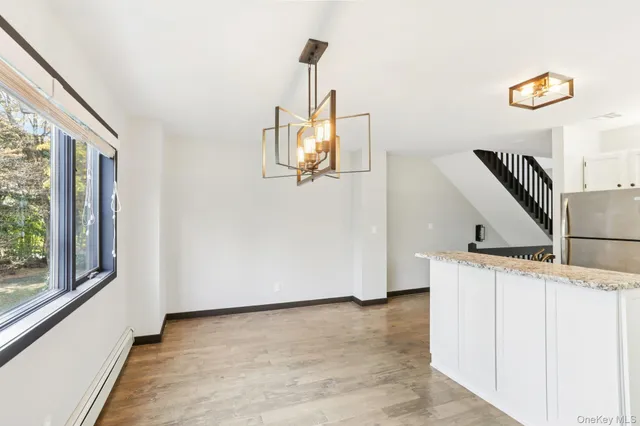 a view of a livingroom with furniture and a window