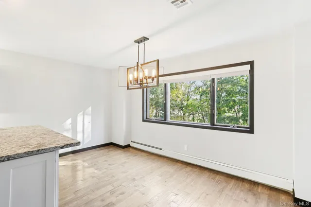 a view of a kitchen with a sink and window