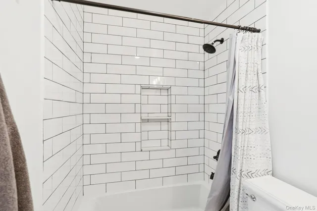 a bathroom with a shower and a toilet