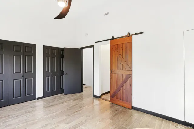 a view of a room with wooden floor and closet