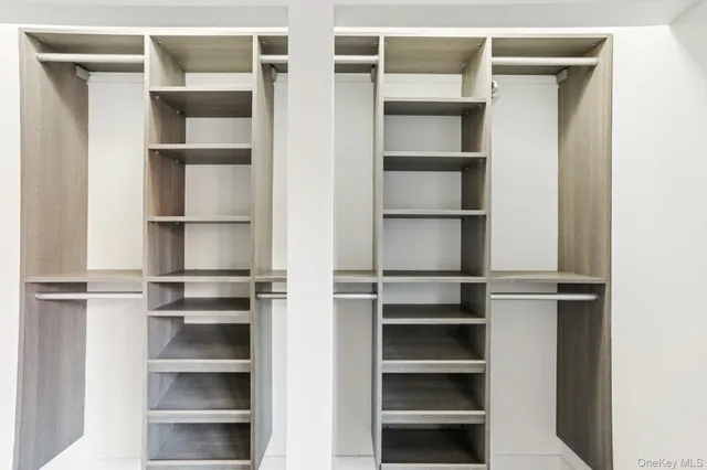 a view of walk in closet with empty racks