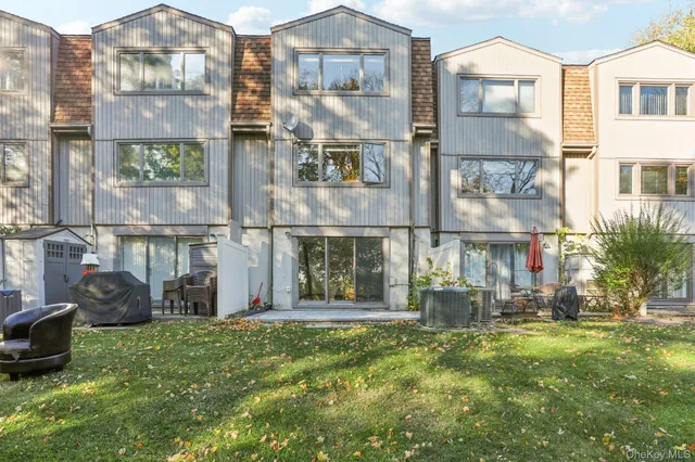 a view of a brick building next to a yard