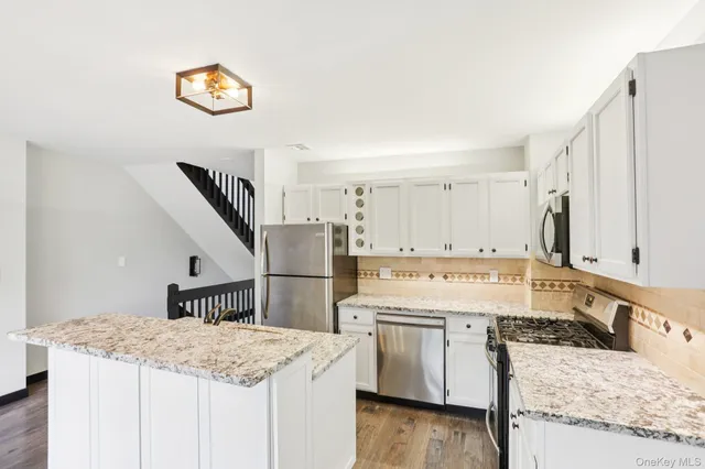 a kitchen with a stove a refrigerator and a sink