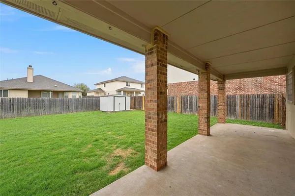 a view of a house with backyard and porch