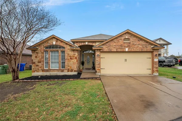 a front view of a house with a yard