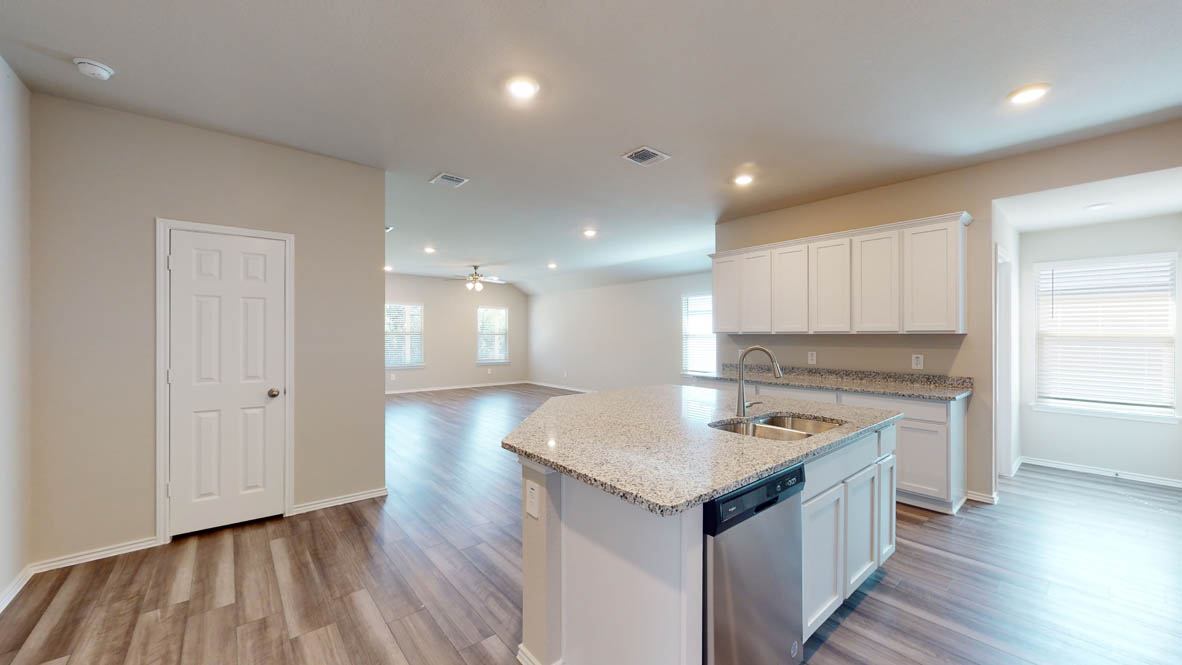 509 Hector Loop Georgetown, TX 78626 - Photo 9 of 31 A well-appointed kitchen island with a double sink and ample granite counter space.