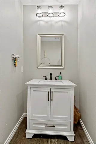 a bathroom with a sink vanity and mirror