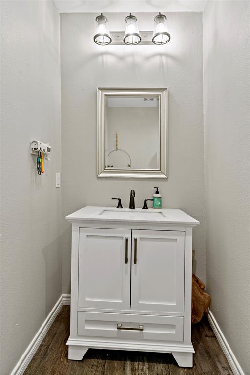 136 Northwest 33rd Paris, TX 75460 - Photo 13 of 14 a bathroom with a sink vanity and mirror