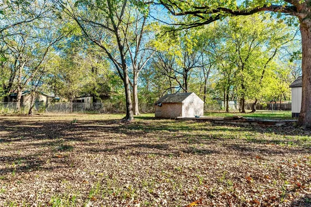 a view of a yard with a house in the background