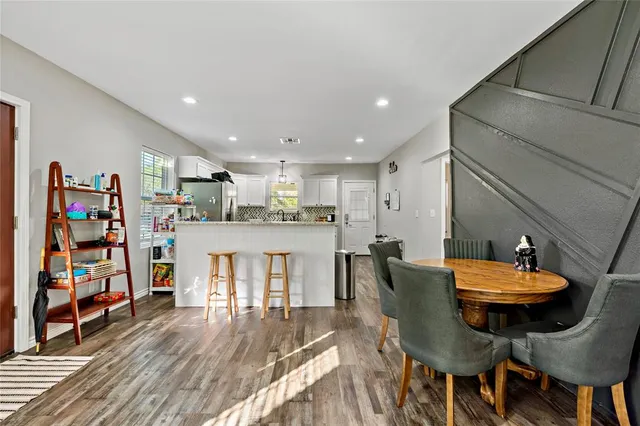 a view of a dining room with furniture and wooden floor