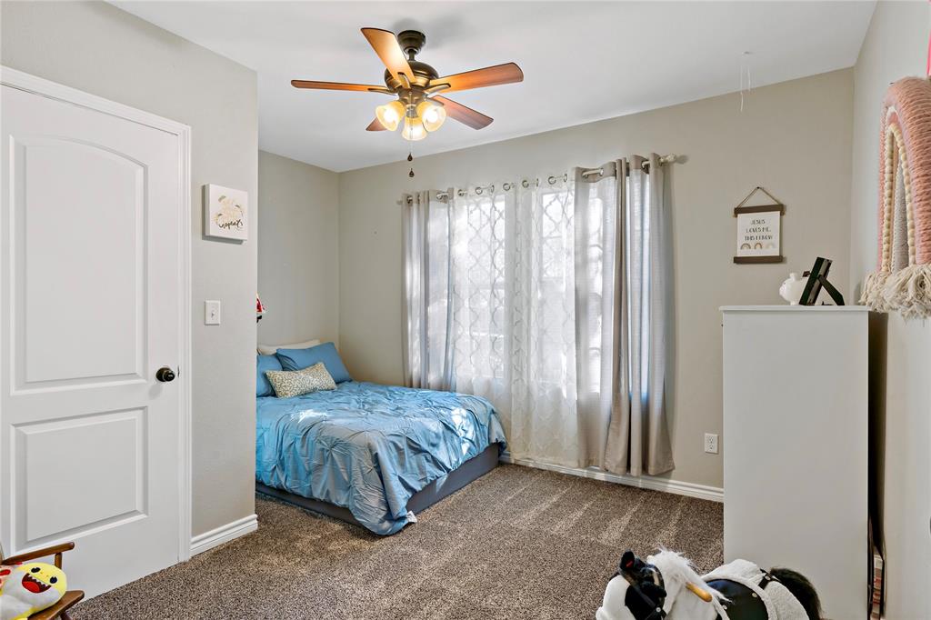 136 Northwest 33rd Paris, TX 75460 - Photo 8 of 14 a bedroom with a bed and a chandelier