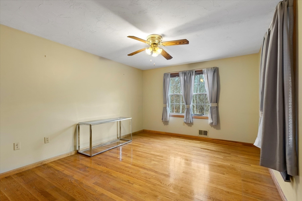 195 High Street Randolph, MA 02368 - Photo 12 of 42 a view of an empty room with window and chandelier fan