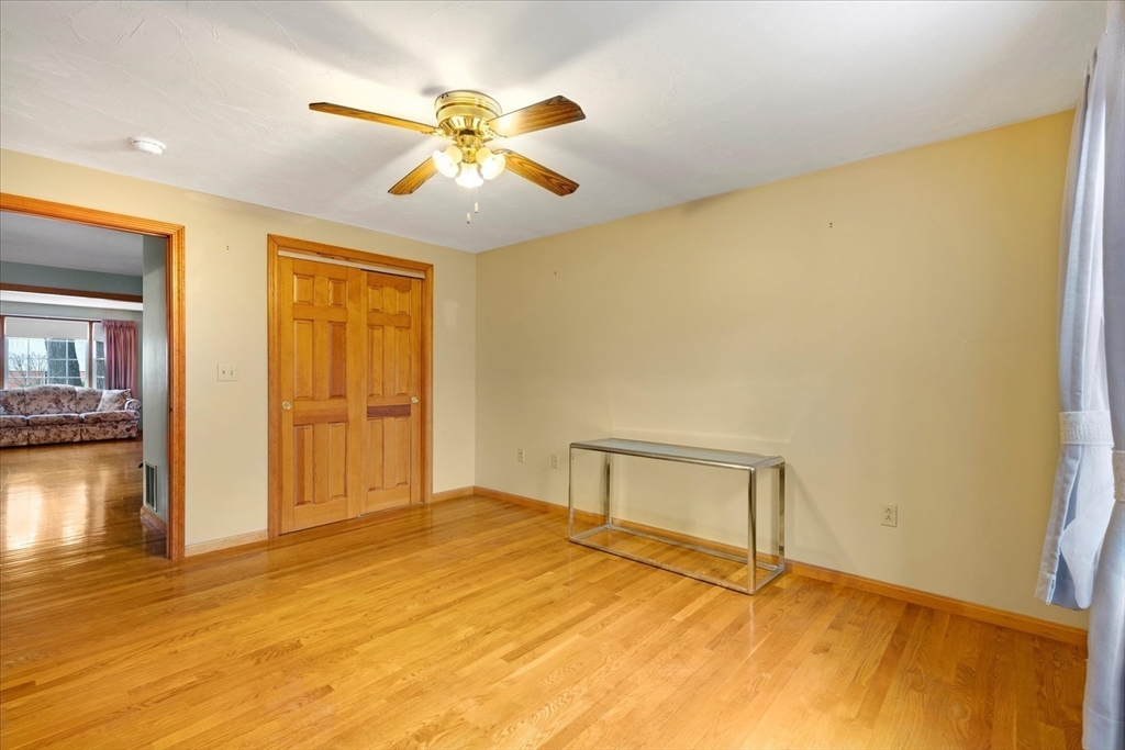 195 High Street Randolph, MA 02368 - Photo 13 of 42 a bedroom with a bed and a chandelier