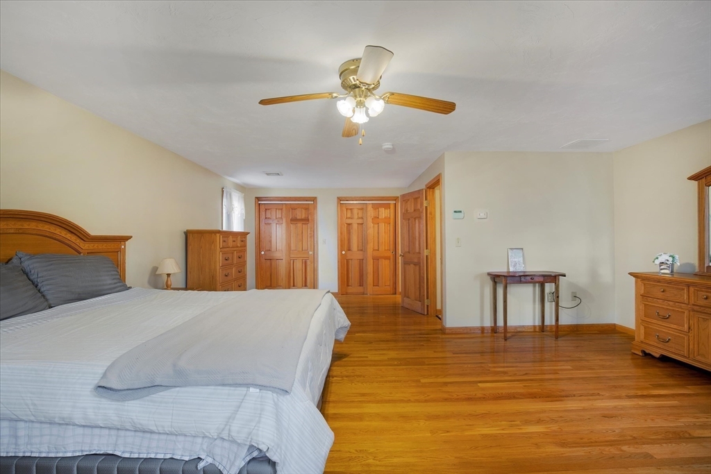 195 High Street Randolph, MA 02368 - Photo 22 of 42 a spacious bedroom with a bed and a table
