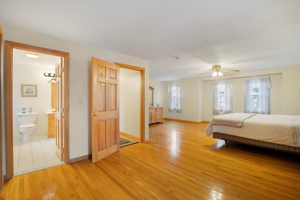 195 High Street Randolph, MA 02368 - Photo 23 of 42 a spacious bedroom with a bed and wooden floor
