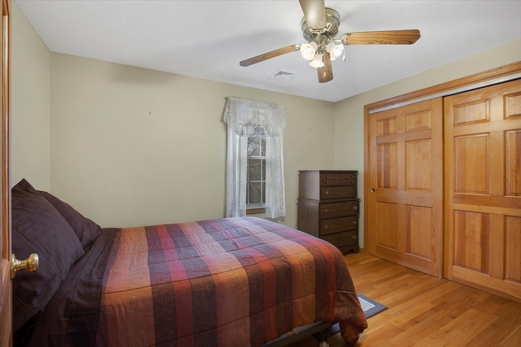 195 High Street Randolph, MA 02368 - Photo 27 of 42 a bedroom with a bed and a chandelier