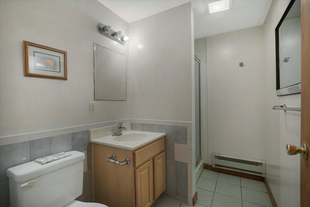 195 High Street Randolph, MA 02368 - Photo 33 of 42 a bathroom with a sink toilet and vanity