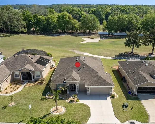 an aerial view of a house with a swimming pool