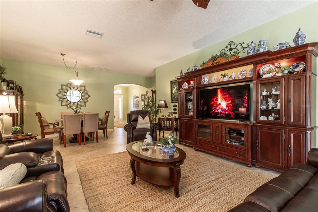 16123 Southwest 14th Avenue Road Ocala, FL 34473 - Photo 12 of 65 a living room with furniture and a flat screen tv