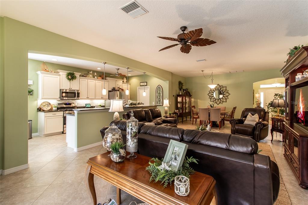 16123 Southwest 14th Avenue Road Ocala, FL 34473 - Photo 13 of 65 a living room with furniture kitchen view and a chandelier