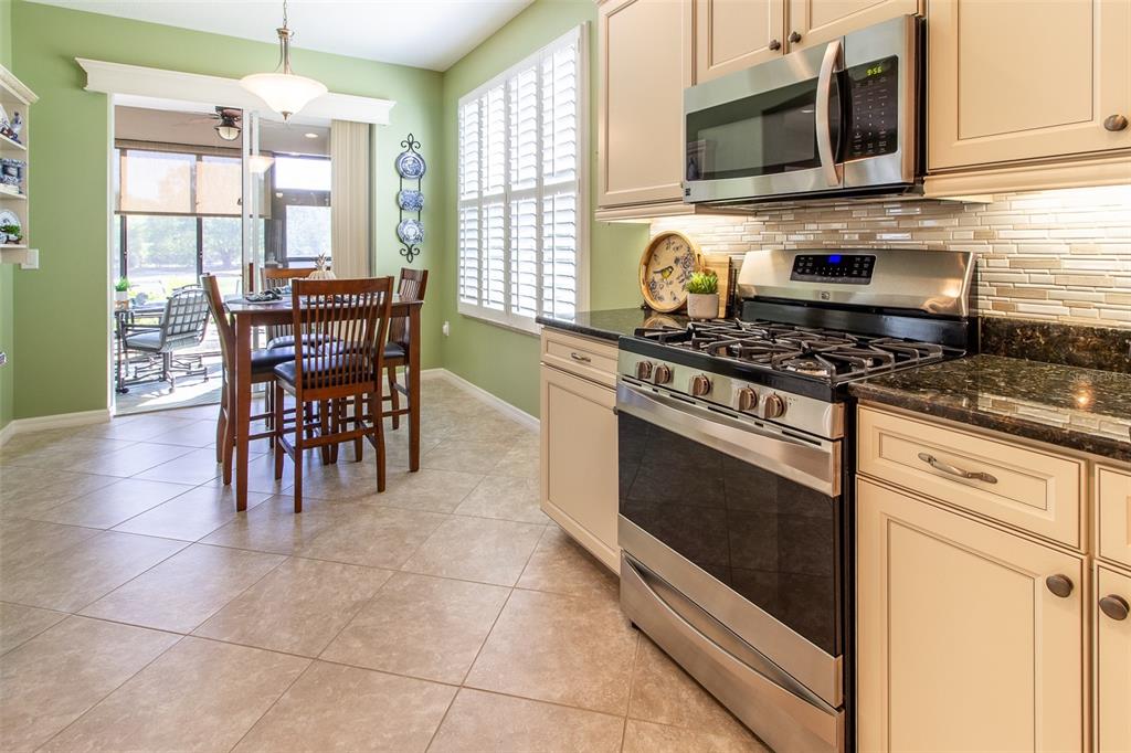 16123 Southwest 14th Avenue Road Ocala, FL 34473 - Photo 20 of 65 a kitchen with stainless steel appliances a stove a sink and a microwave