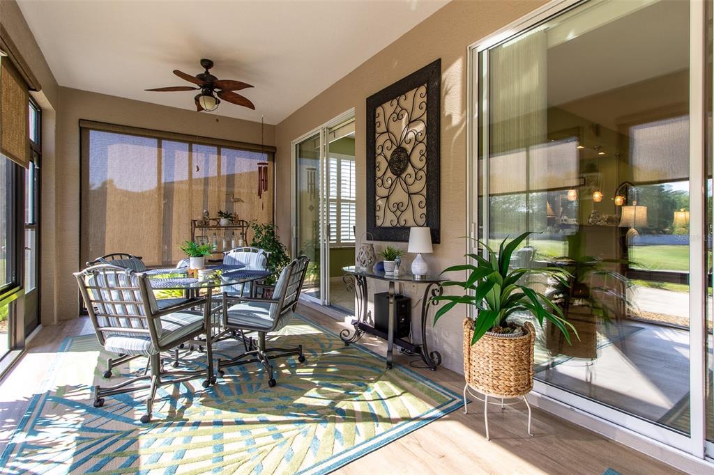 16123 Southwest 14th Avenue Road Ocala, FL 34473 - Photo 25 of 65 a dining room with furniture a potted plant and a floor to ceiling window