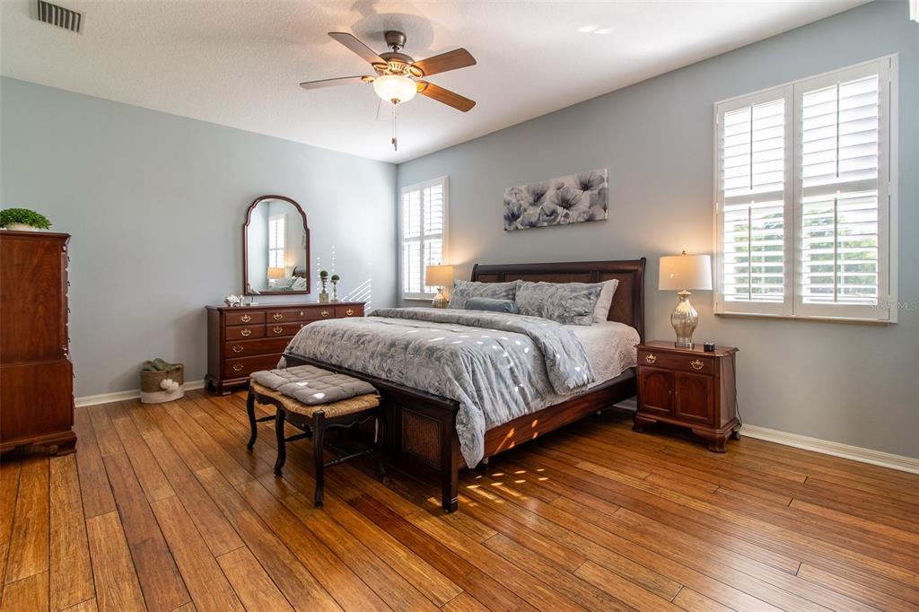 16123 Southwest 14th Avenue Road Ocala, FL 34473 - Photo 28 of 65 a bedroom with a bed chandelier and a window