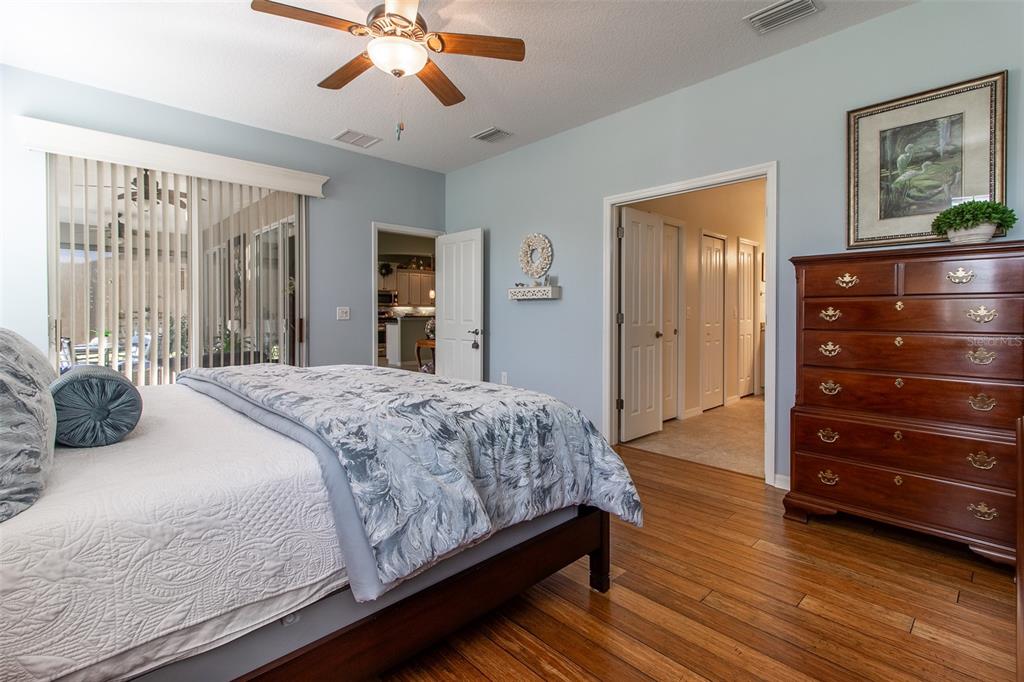 16123 Southwest 14th Avenue Road Ocala, FL 34473 - Photo 29 of 65 a bedroom with a bed and a chandelier