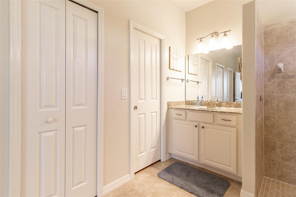 16123 Southwest 14th Avenue Road Ocala, FL 34473 - Photo 32 of 65 a bathroom with a double vanity sink and a mirror