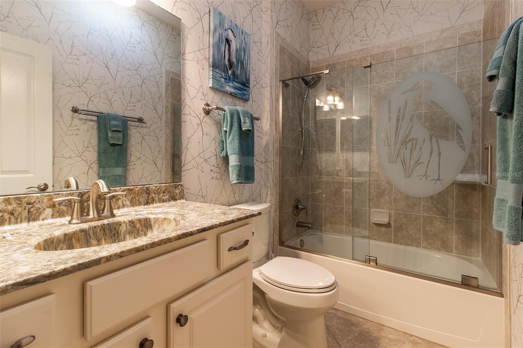 16123 Southwest 14th Avenue Road Ocala, FL 34473 - Photo 39 of 65 a bathroom with a sink a toilet and shower