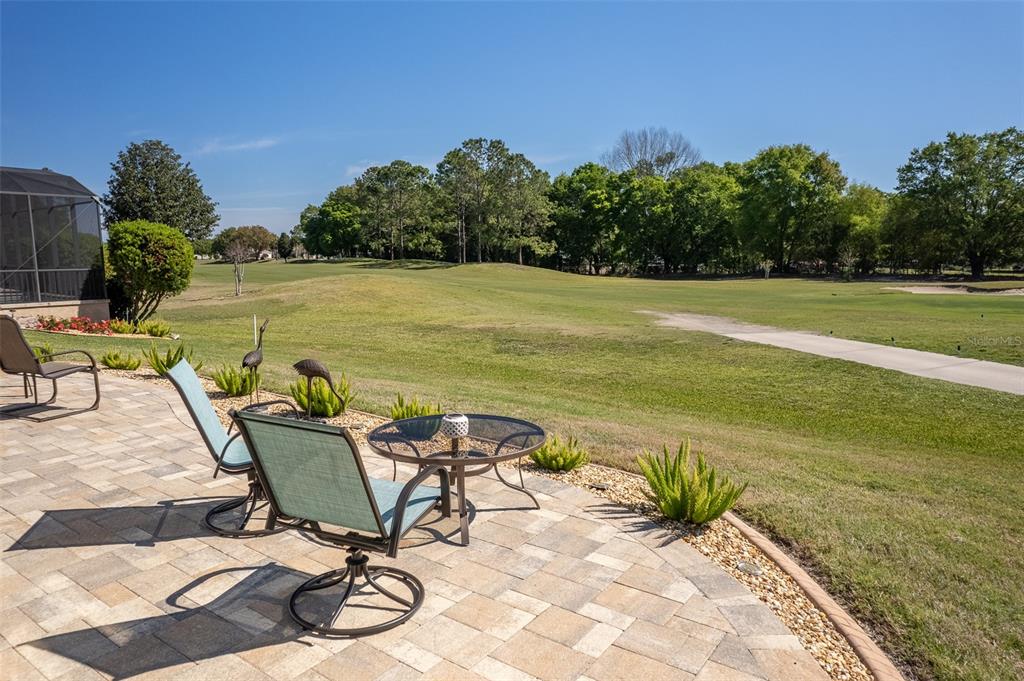 16123 Southwest 14th Avenue Road Ocala, FL 34473 - Photo 4 of 65 a view of a swimming pool with chair and table in the backyard