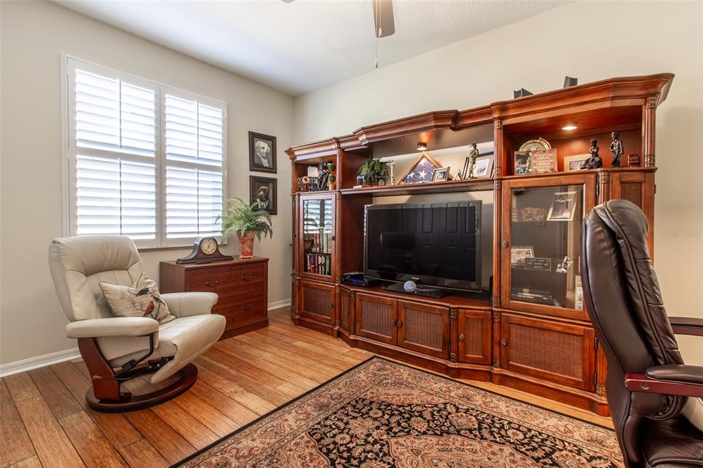 16123 Southwest 14th Avenue Road Ocala, FL 34473 - Photo 41 of 65 a living room with furniture and a flat screen tv