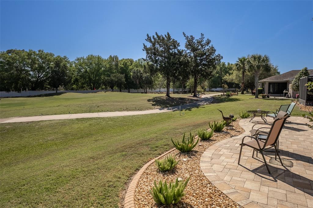 16123 Southwest 14th Avenue Road Ocala, FL 34473 - Photo 52 of 65 a view of a swimming pool with a yard and sitting area