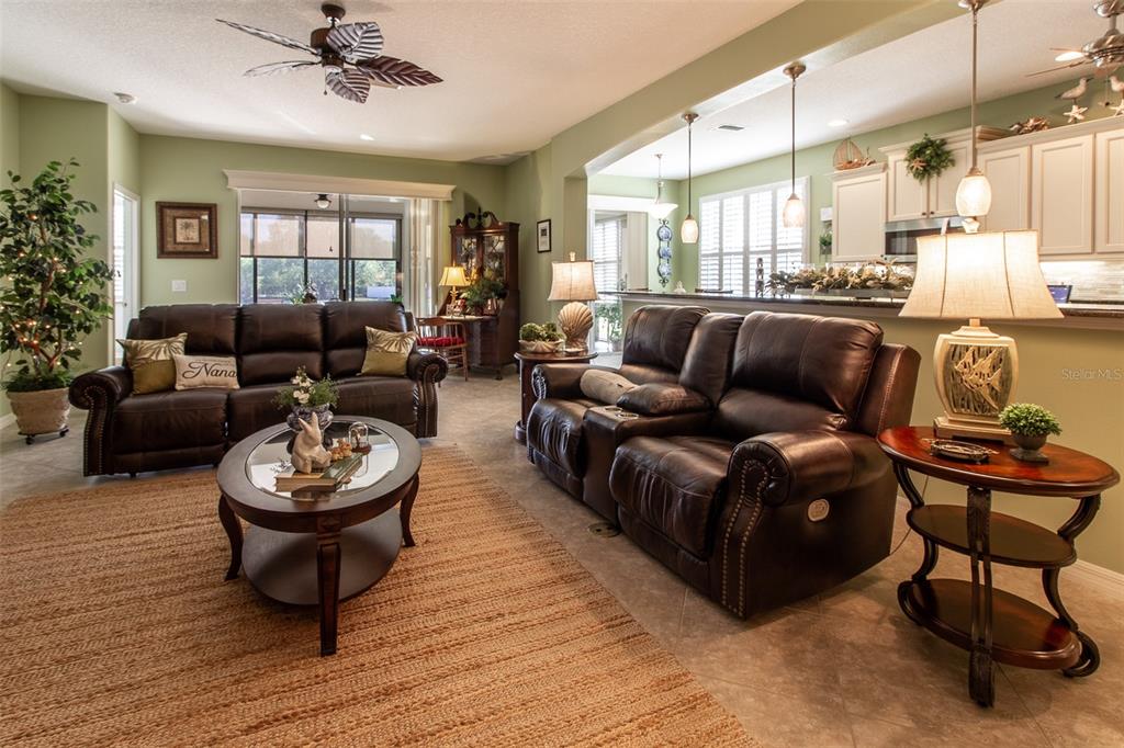 16123 Southwest 14th Avenue Road Ocala, FL 34473 - Photo 10 of 65 a living room with furniture and a wooden floor