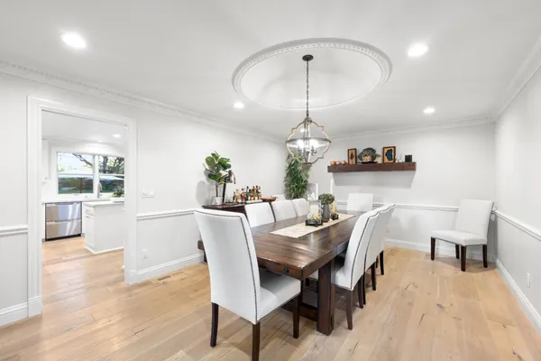 a view of a dining room with furniture window and wooden floor