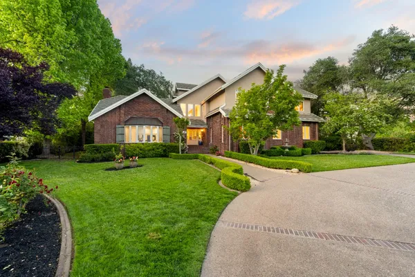 a view of house with yard and green space