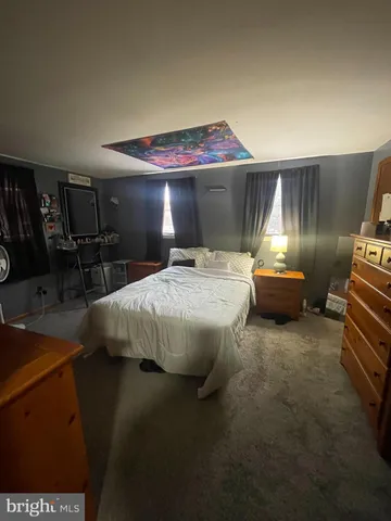 a bedroom with a bed and a desk