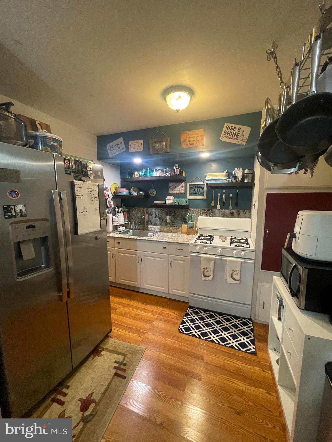 12123 Rambler Road Philadelphia, PA 19154 - Photo 9 of 29 a kitchen with stainless steel appliances granite countertop a sink a stove and a refrigerator