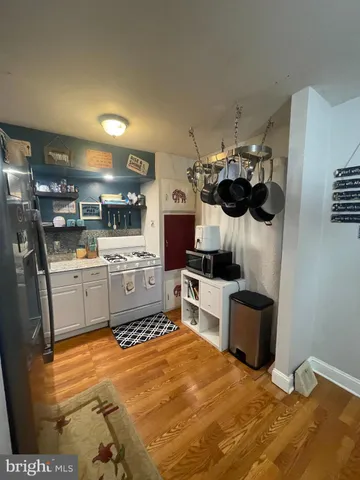 a kitchen with stainless steel appliances kitchen island granite countertop a sink and a stove