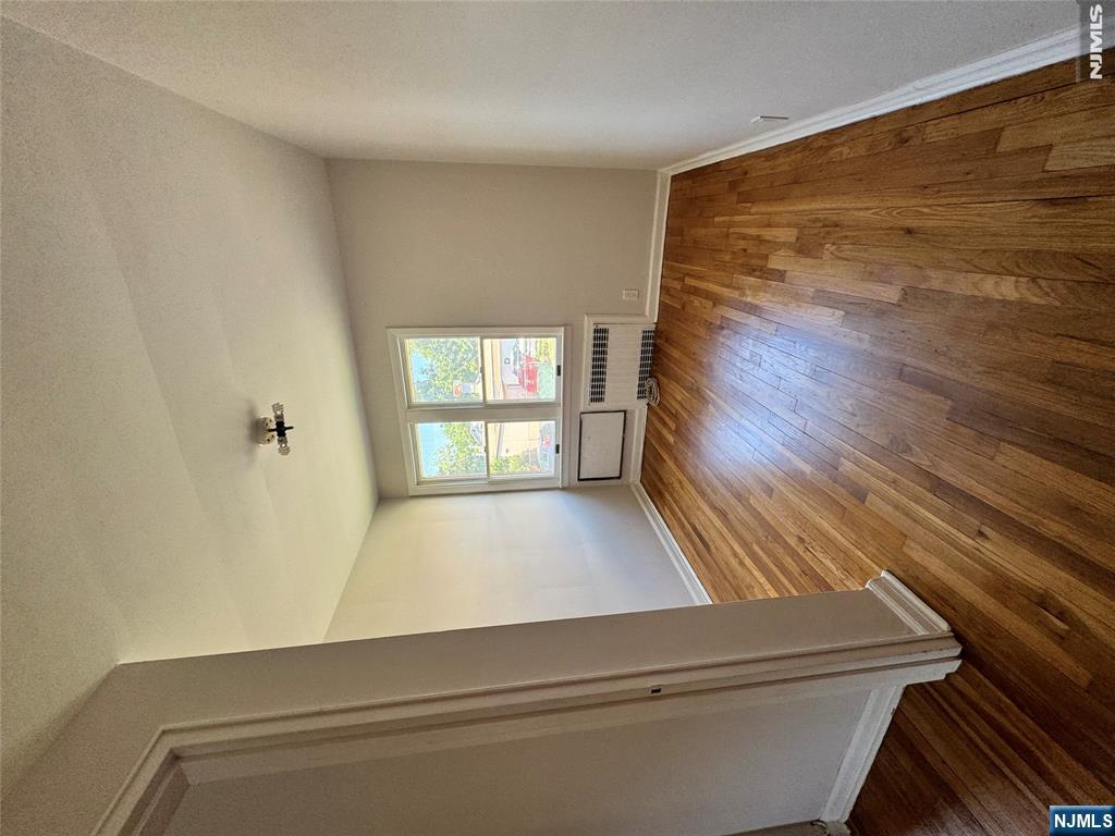 251 Fort Lee Road, Unit D Teaneck, NJ 07666 - Photo 10 of 14 an empty room with wooden floor and windows