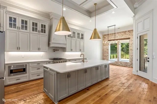 a kitchen with a stove and a wooden floors