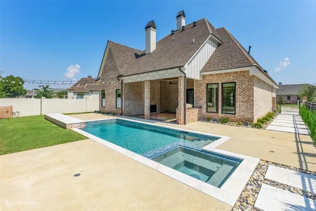 a view of a white house with a big yard and potted plants