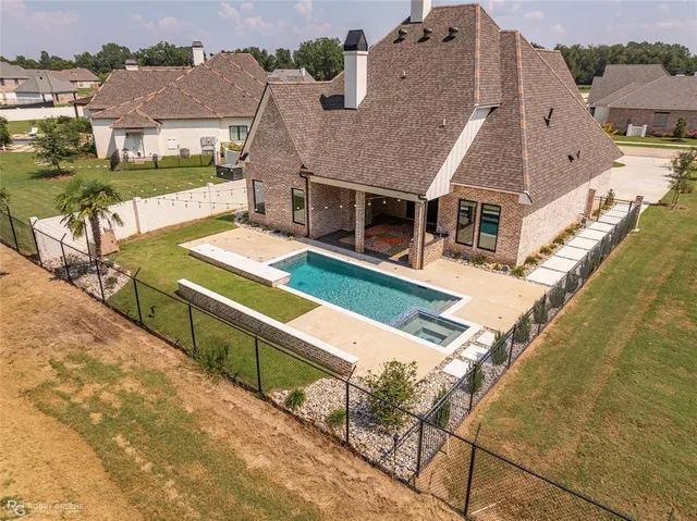 an aerial view of a house with swimming pool