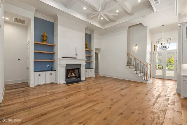 a view of an empty room with a fireplace and a window