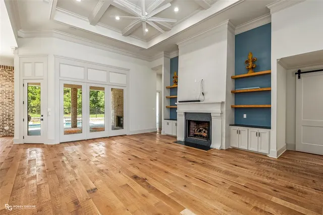 a view of an empty room with window and fire place