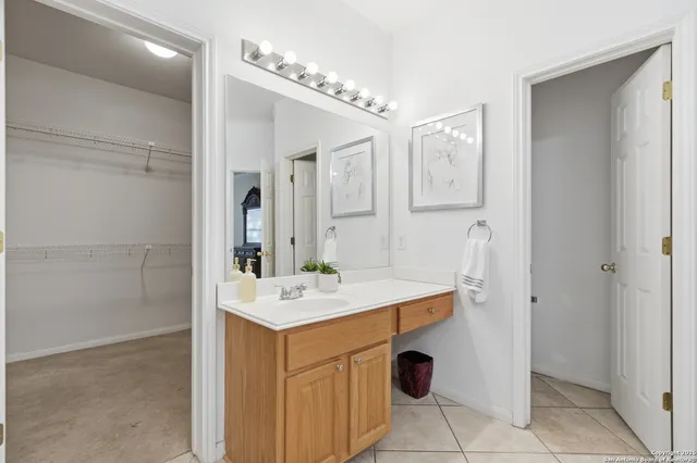a bathroom with a sink vanity and mirror