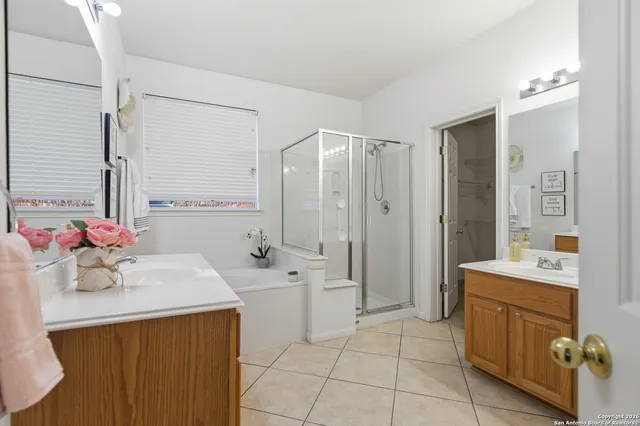a bathroom with a sink a tub and a mirror