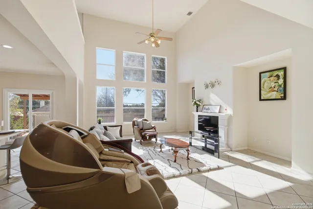 a living room with furniture and floor to ceiling windows
