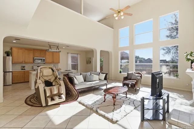 a living room with furniture gym equipment and large windows